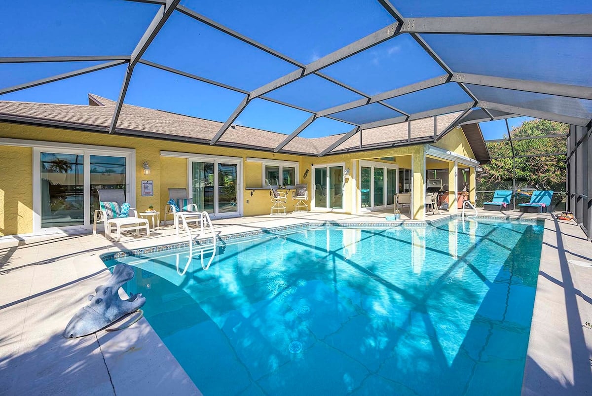 Beheizter Pool mit überdachter Veranda und Blick auf den Kanal.