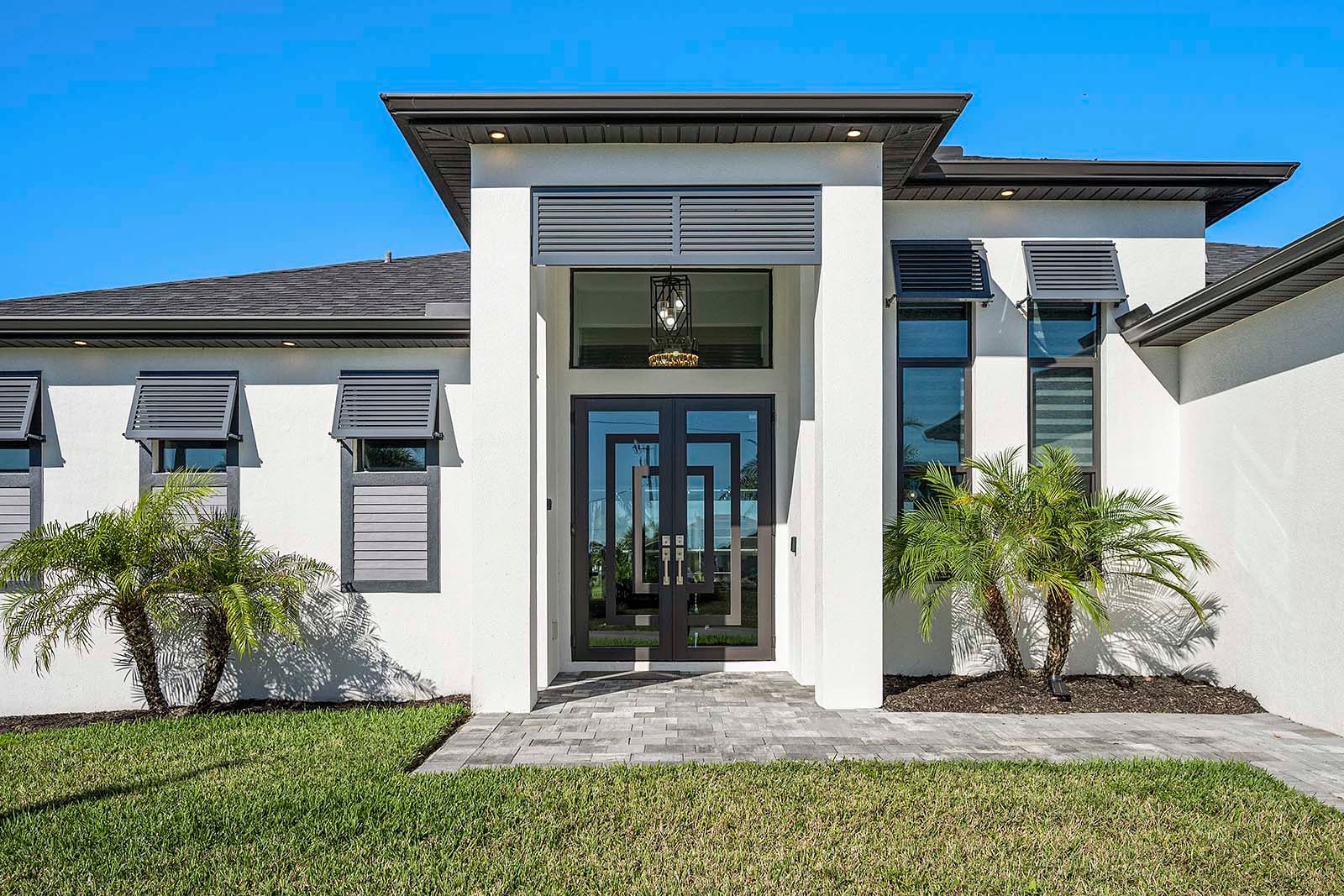 Terrasse am Kanal mit Sitzbereich, Grill und Feuerstelle bei Sonnenuntergang.