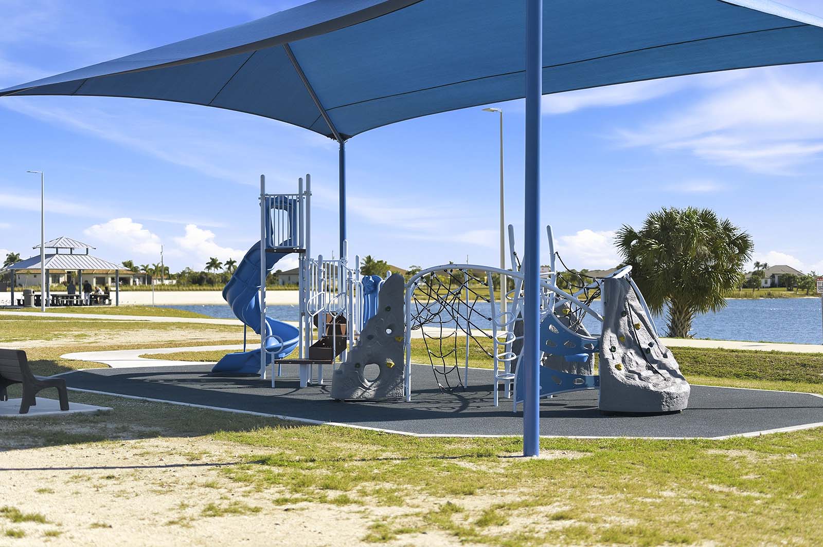 Terrasse am Kanal mit Grill, Feuerstelle und Sitzbereich bei Sonnenuntergang.