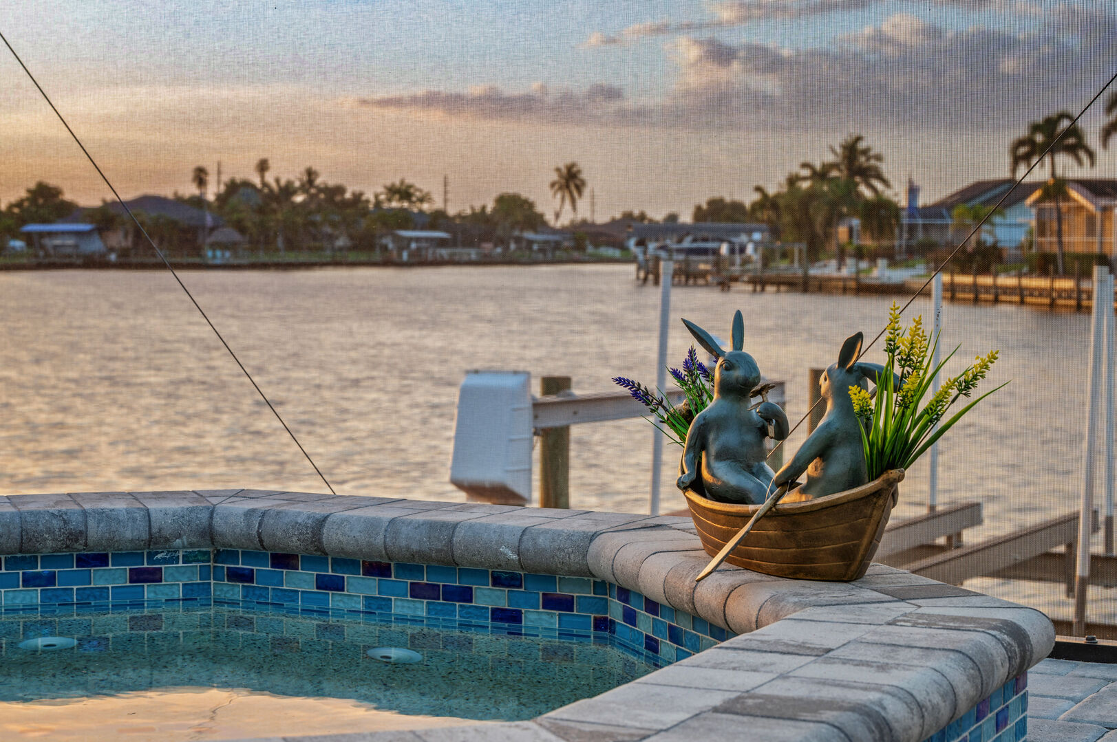 Blick auf den Kanal mit Bootsdock und Bootslift bei Sonnenuntergang.