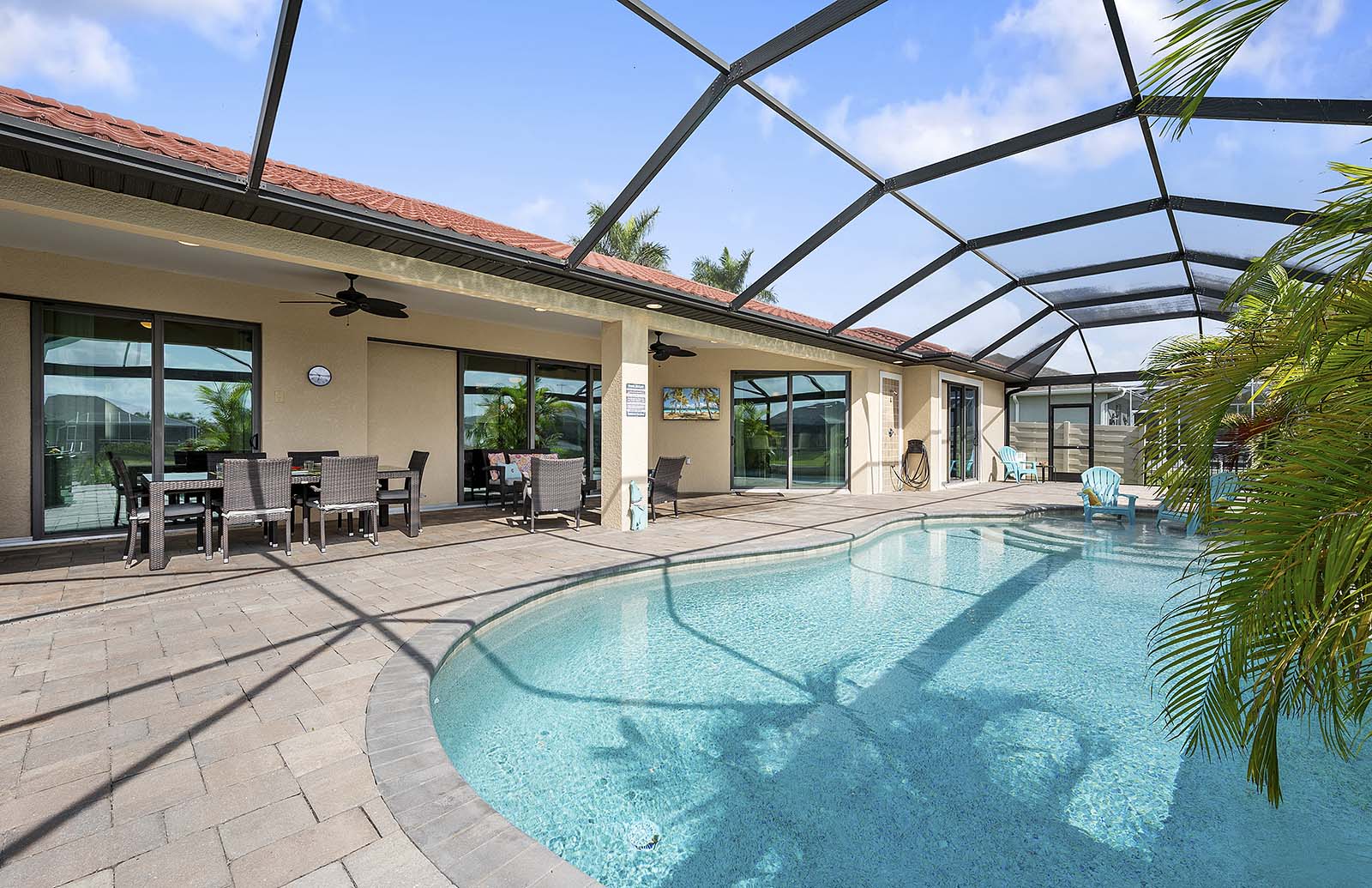 Blick vom Kanal auf die Terrasse mit Bootssteg und Sitzbereich.