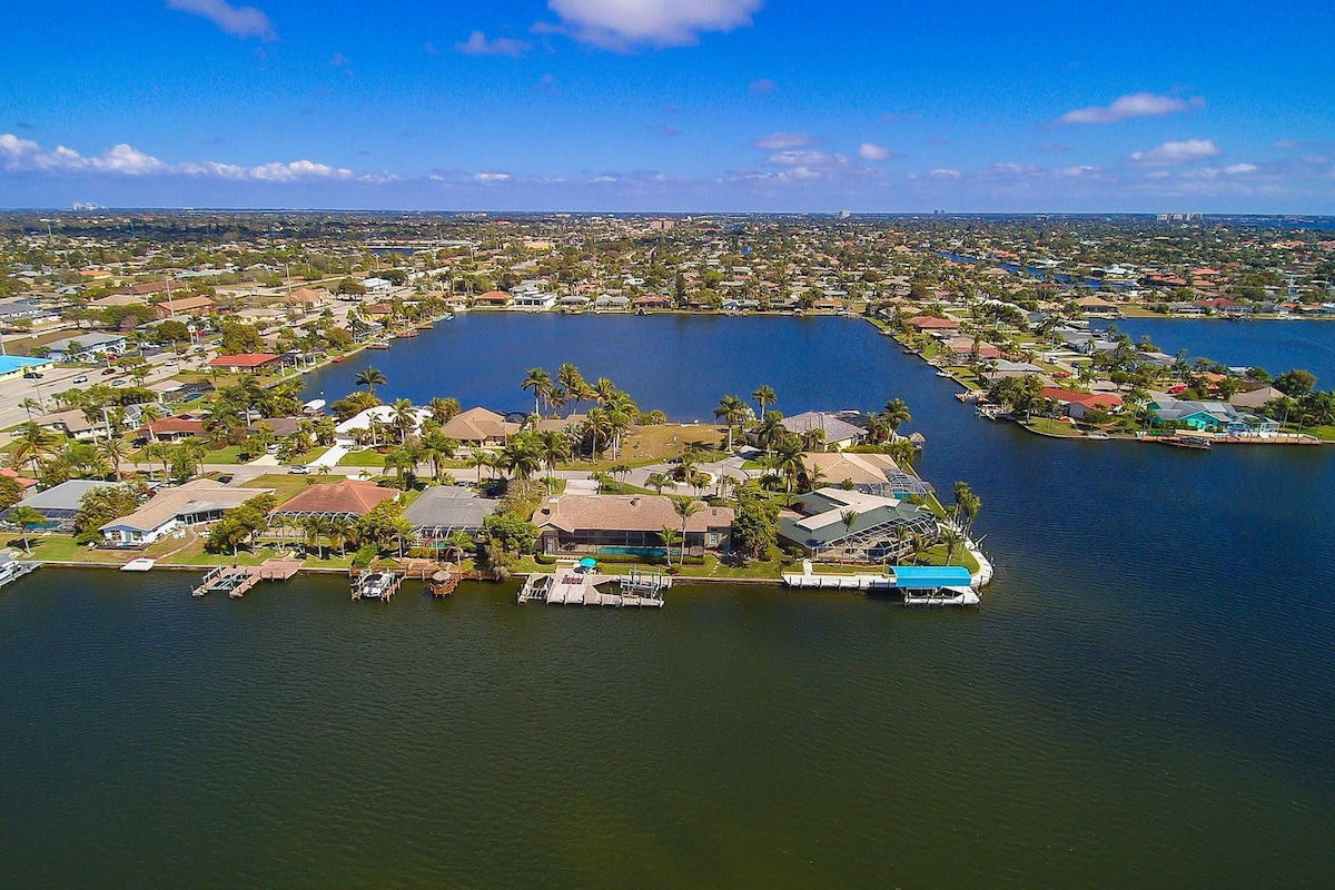 Überdachte Veranda am Kanal mit Sitzbereich und Blick aufs Wasser.