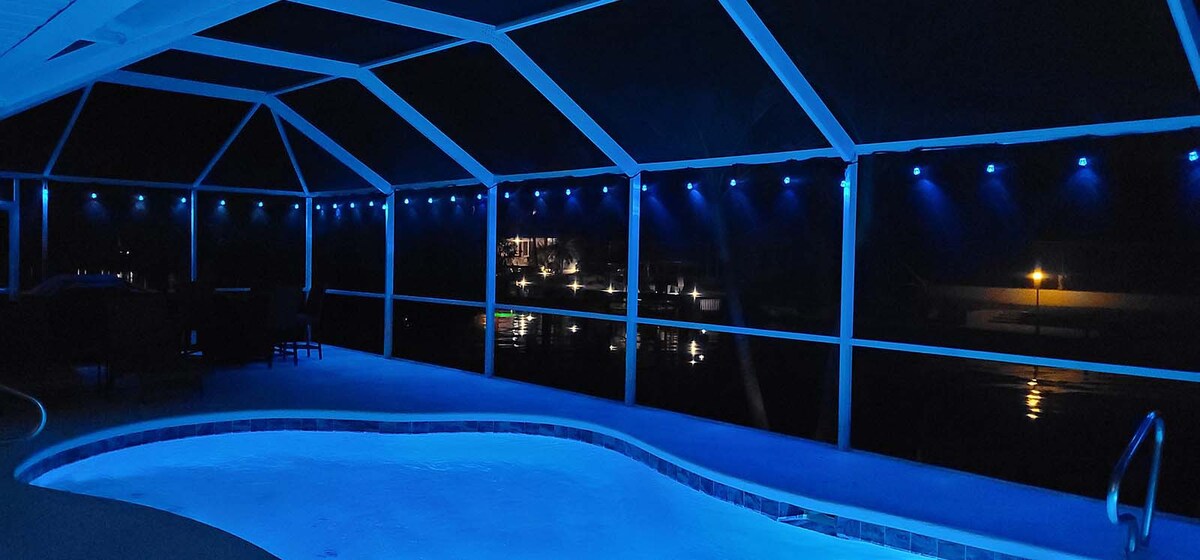 Beheizter Pool mit Lanai und Kanalblick bei Sonnenuntergang.