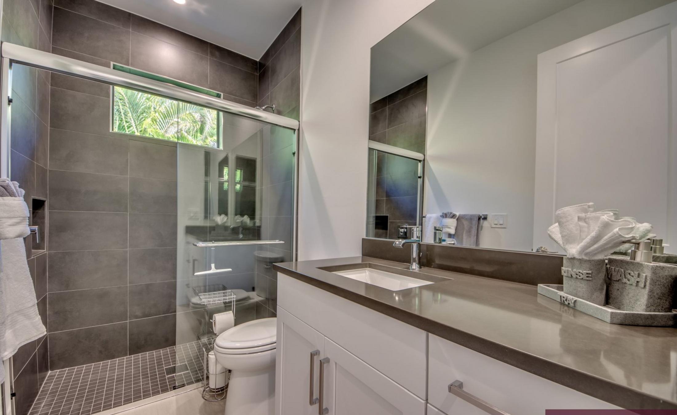 Sonniger Poolbereich am Kanal mit Liegen, Spa und Bootsdock.