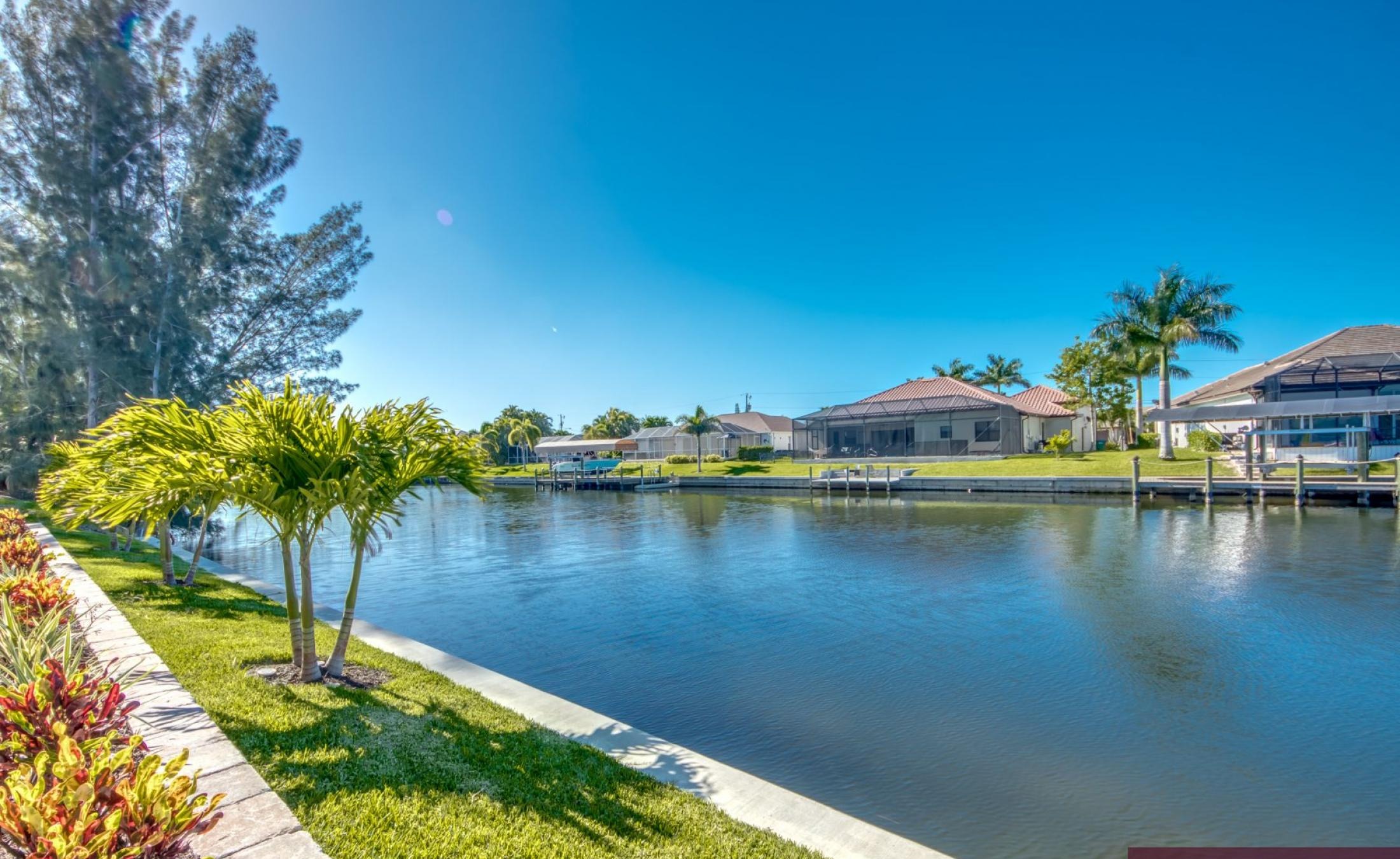 Blick auf den privaten Pool mit Spa und Bootsdock am Kanal.