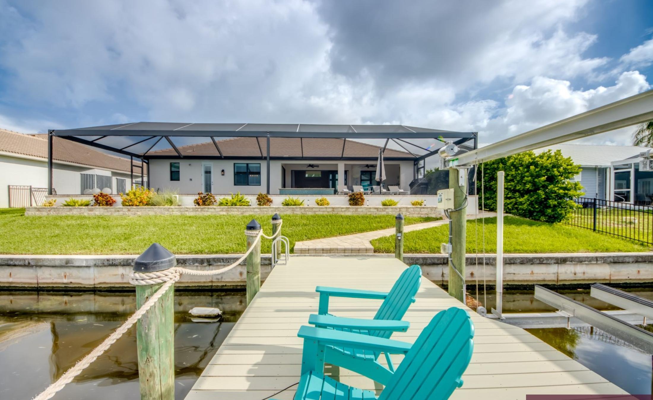 Beheizter Pool mit Spa und Sonnenterrasse am Wasser.