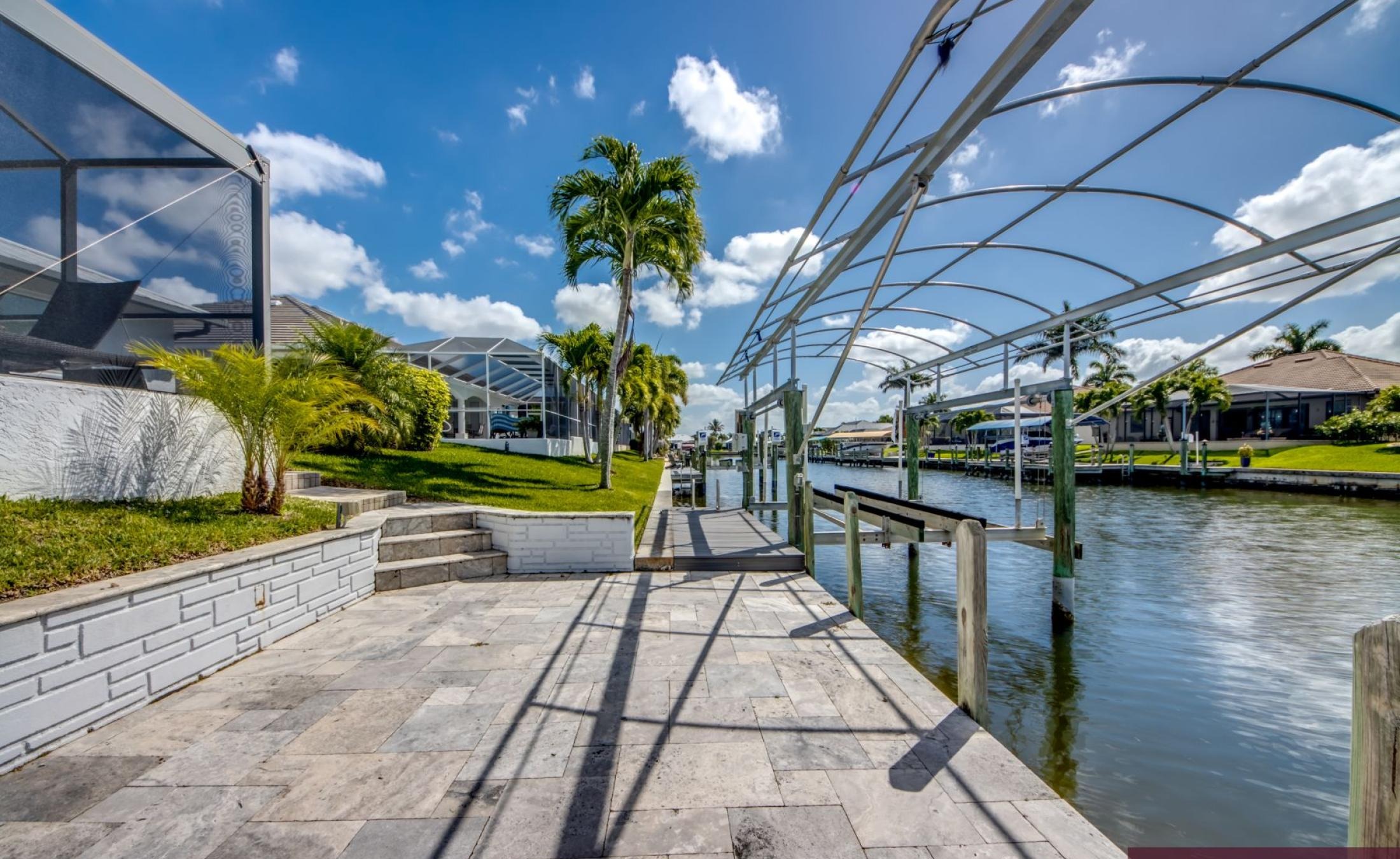 Sonniges Pooldeck mit beheiztem Pool am Kanal und privatem Bootsdock.