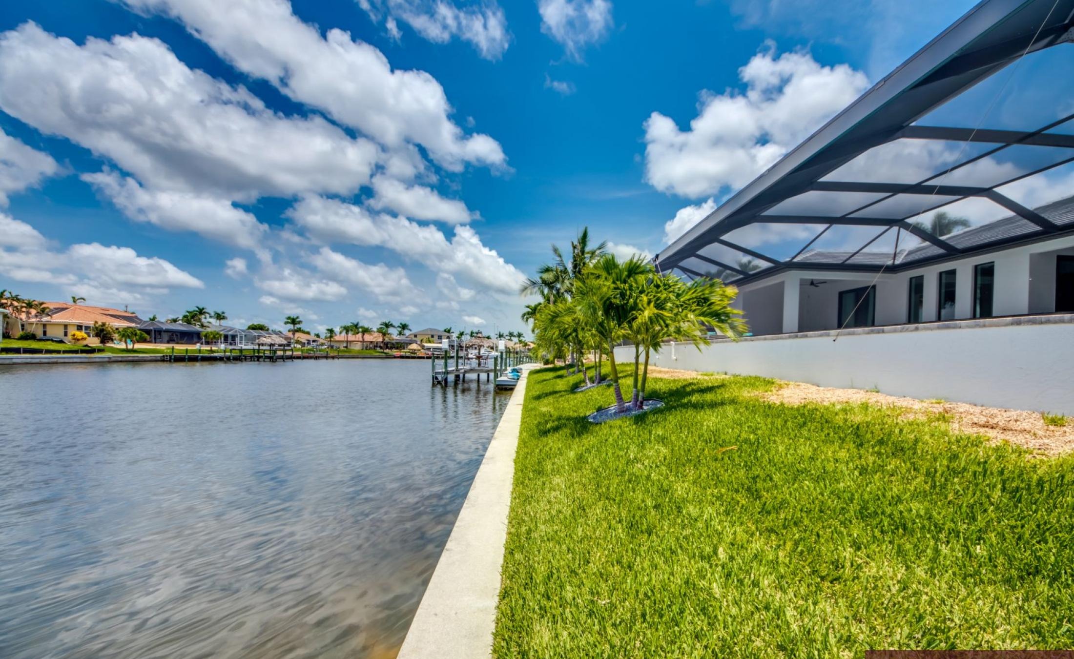 Beheizter Pool mit Spa auf sonnigem Pooldeck am Kanal mit Bootsdock und Lift.