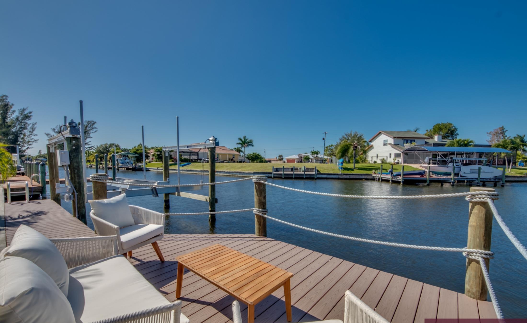 Elektrisch beheizter Pool mit Spa und Blick auf den Kanal bei Sonnenuntergang.