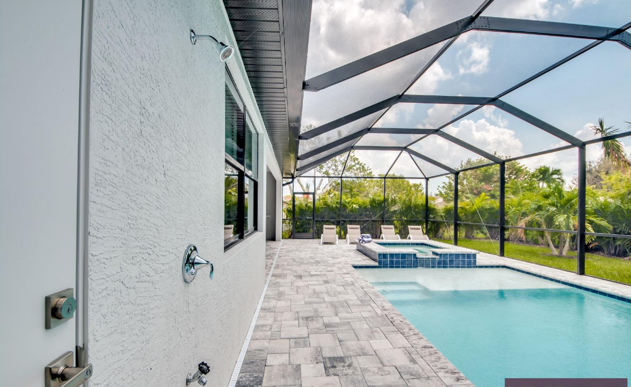 Helles Wohn- und Esszimmer mit offener Küche und Blick auf den Poolbereich.