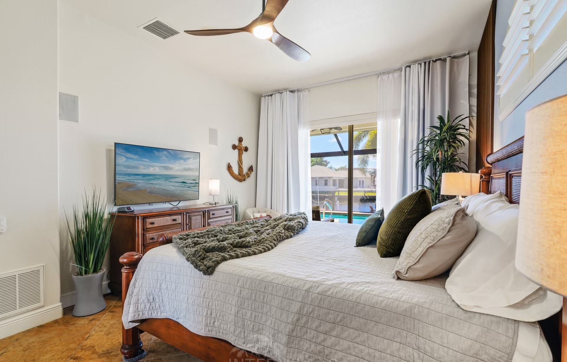 Überdachte Lanai mit Sitzbereich, Outdoor-Küche und Blick auf den Kanal.