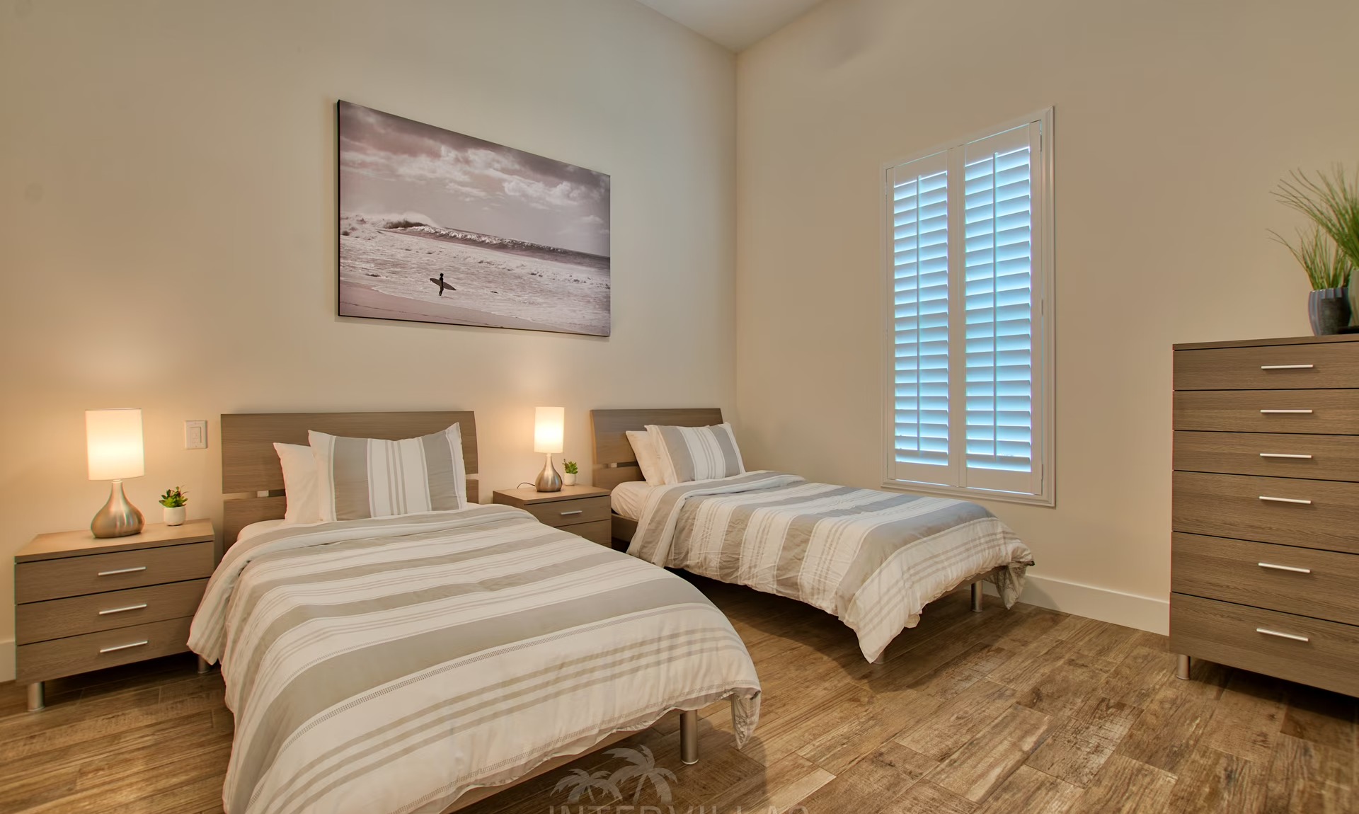 Moderne Villa am Kanal mit sonnigem Poolbereich und Blick aufs Wasser.