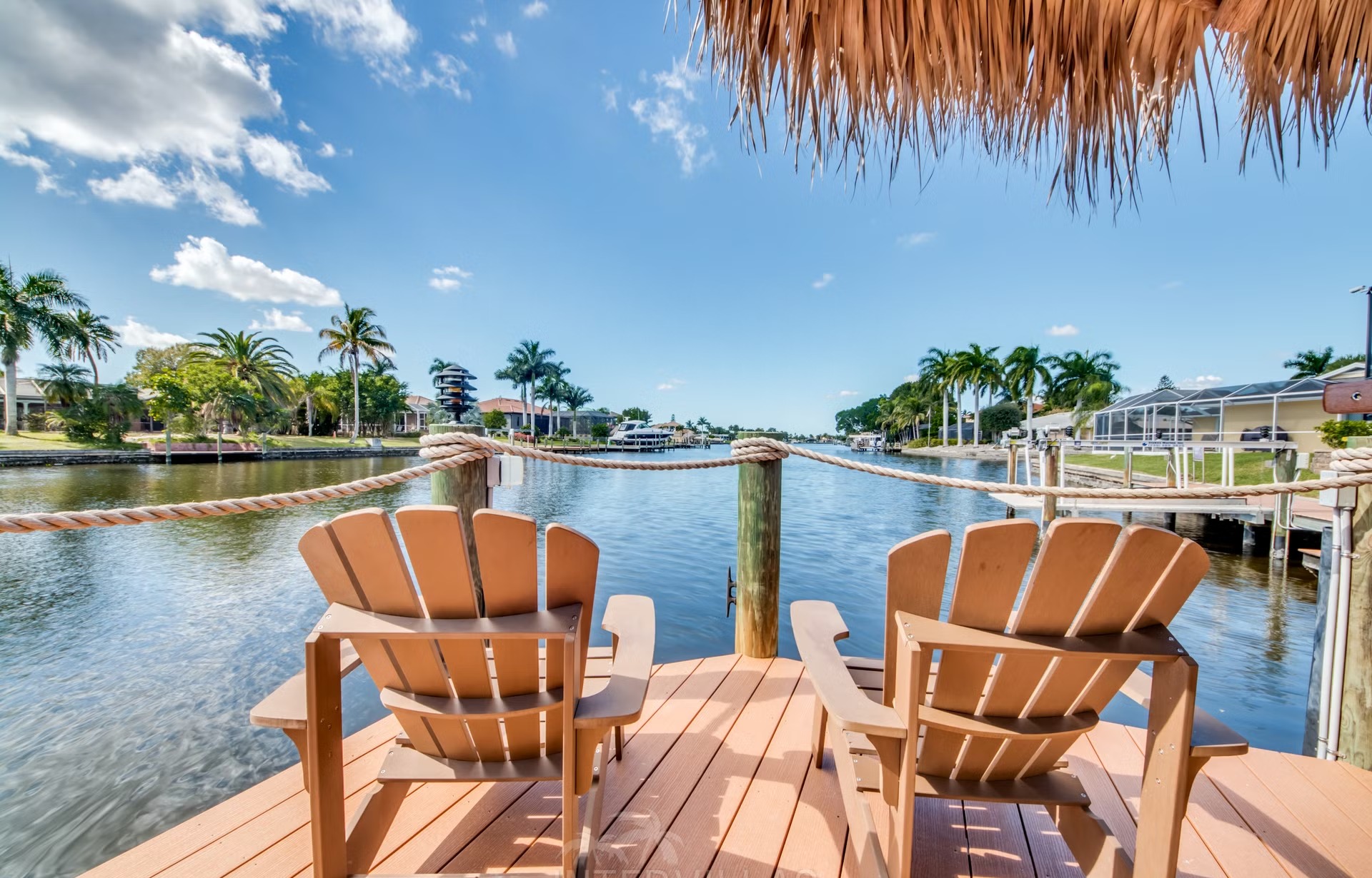 Dock am Kanal mit Tiki-Hut und Kajaks.