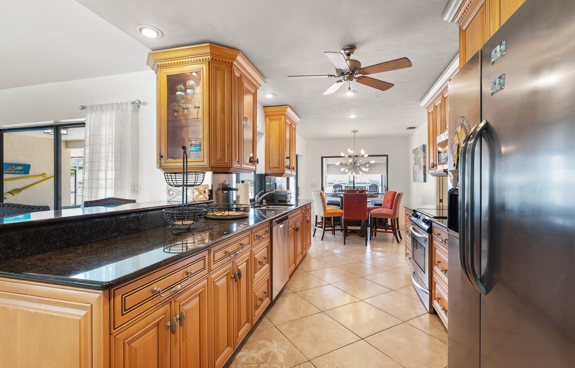 Beheizter Pool mit überdachtem Sitzbereich und Außenküche mit Blick aufs Wasser.