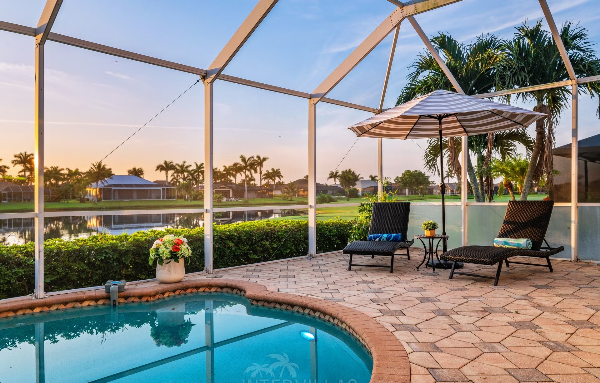 Überdachter Outdoor-Bereich mit Sitzgruppe und Blick auf den See.