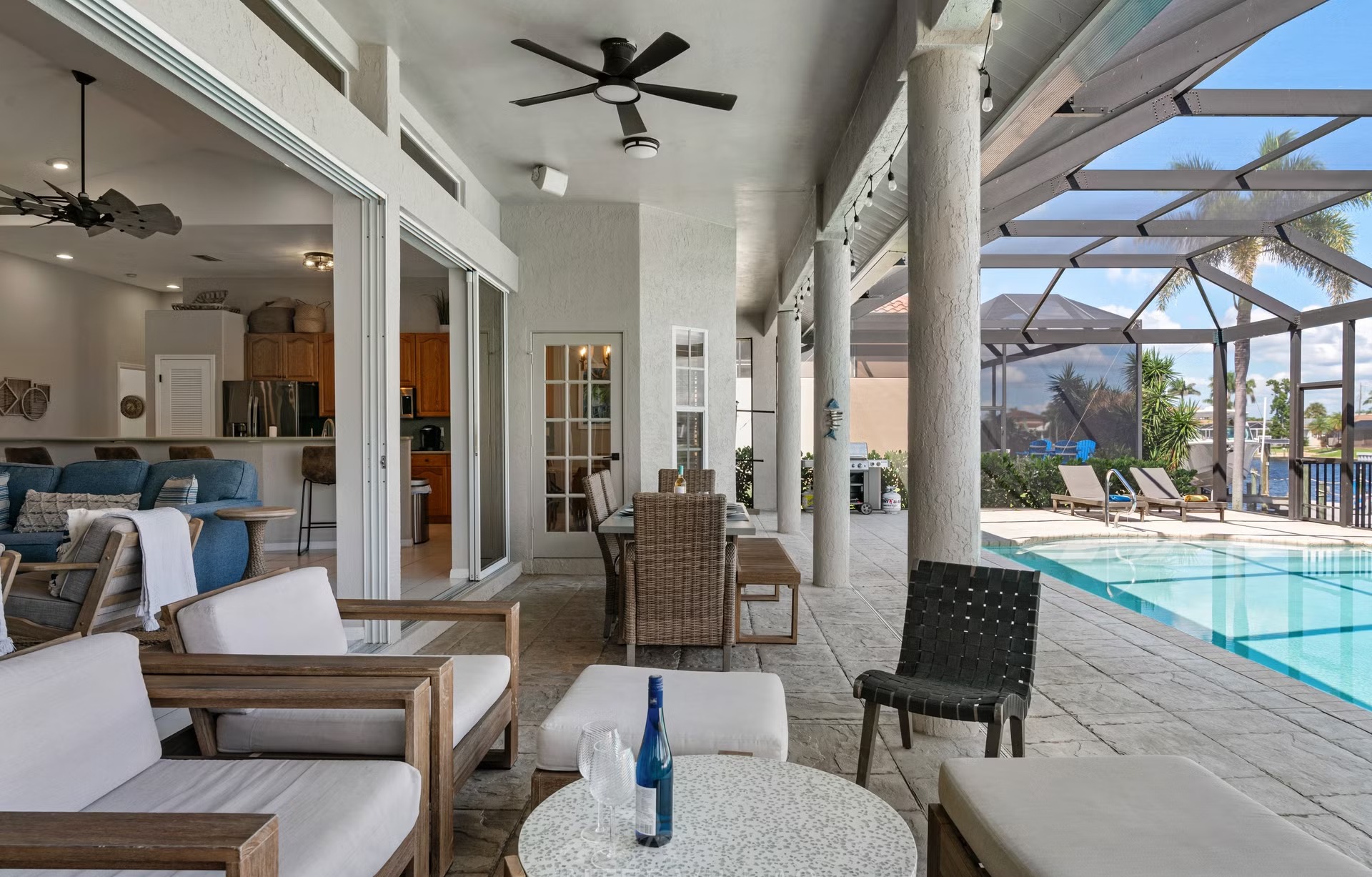 Poolbereich mit Outdoorküche und Blick auf den Kanal