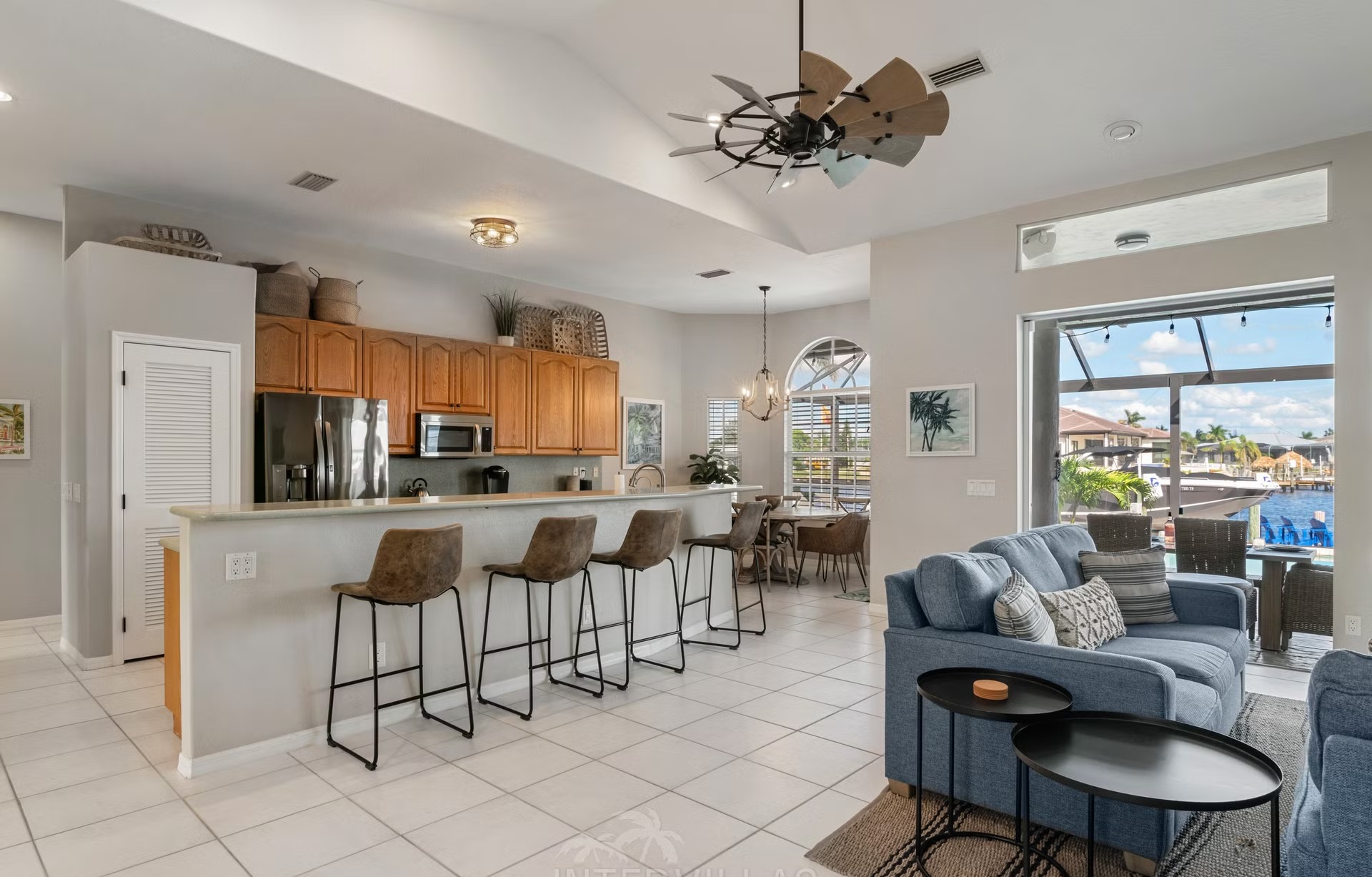 Poolbereich mit Outdoorküche und Blick auf den Kanal.