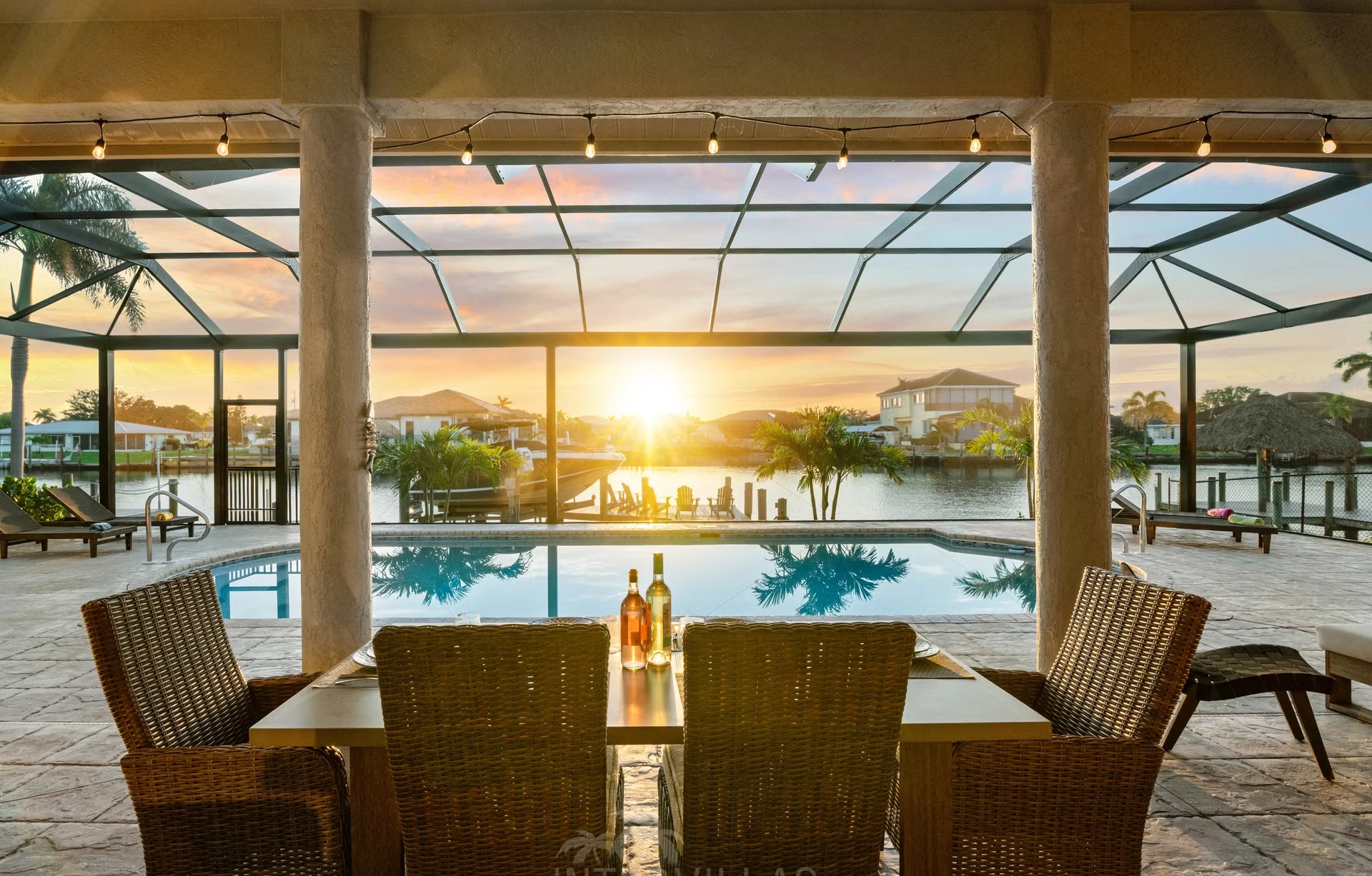 Poolbereich mit Outdoorküche und Blick auf den Kanal.