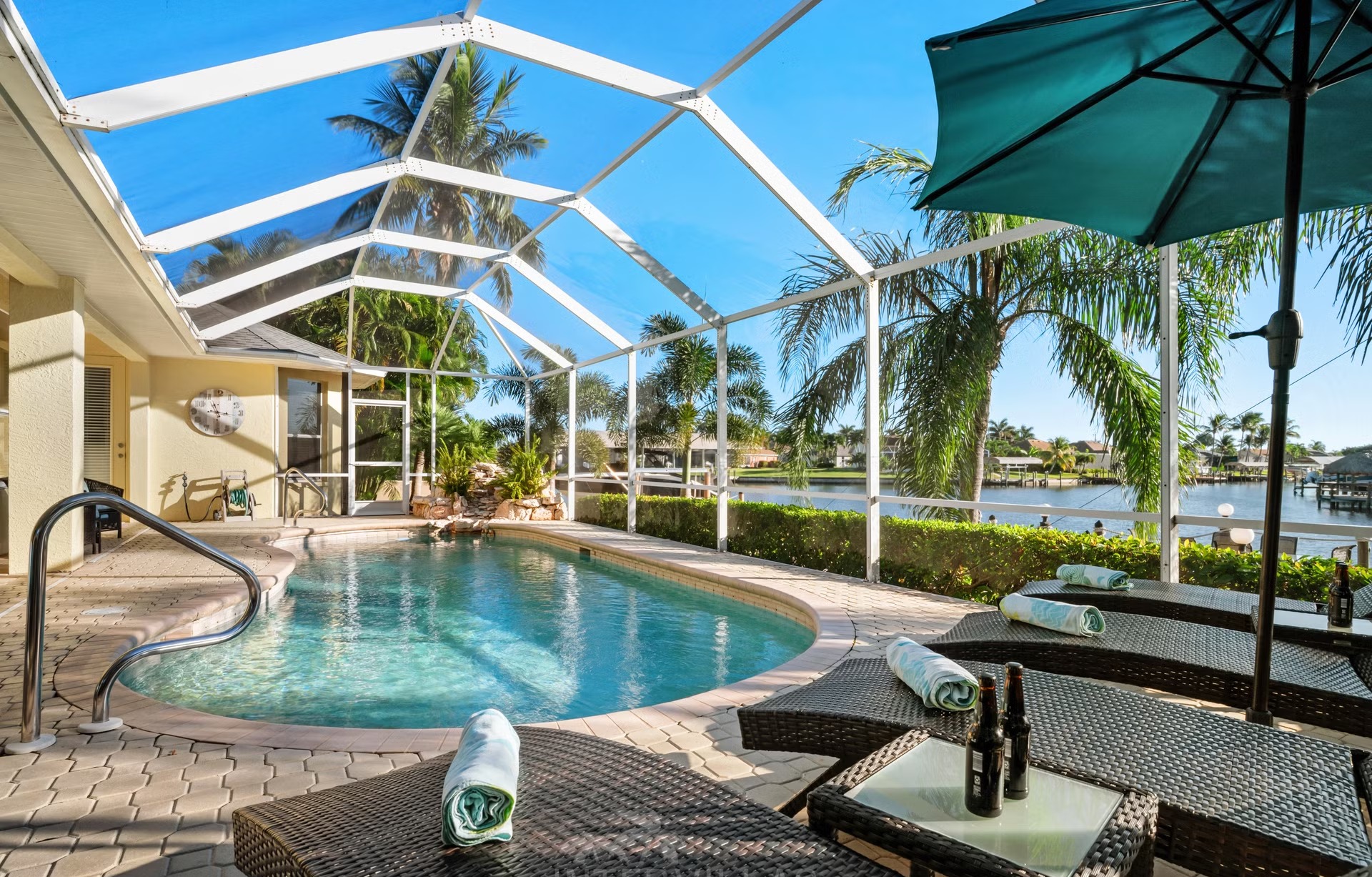 Beheizter Poolbereich mit Liegen, Lanai und Blick auf den Kanal am privaten Dock.
