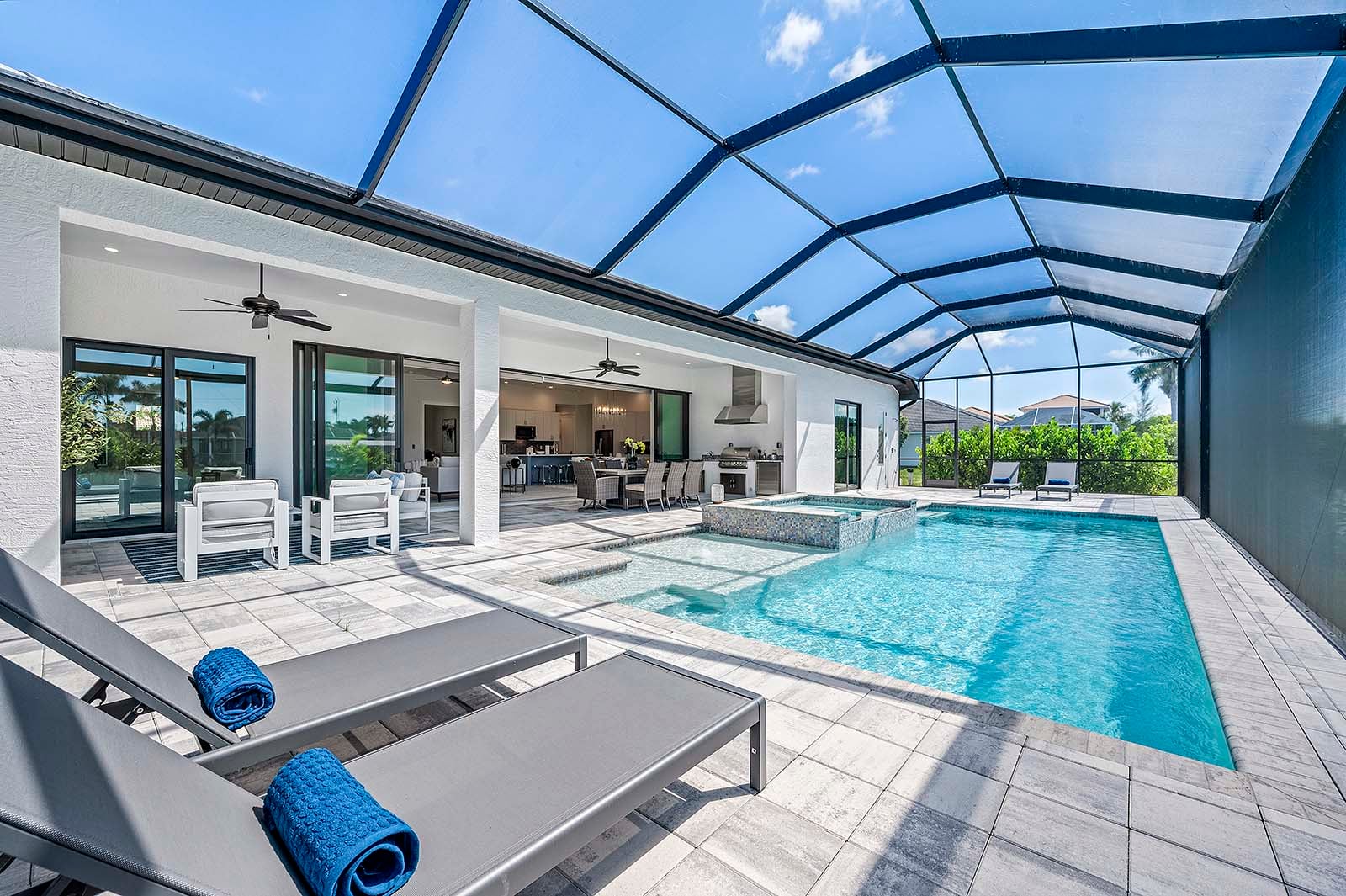 Sonnige Poolterrasse am Kanal mit Salzwasser-Pool, Spa und Liegen.