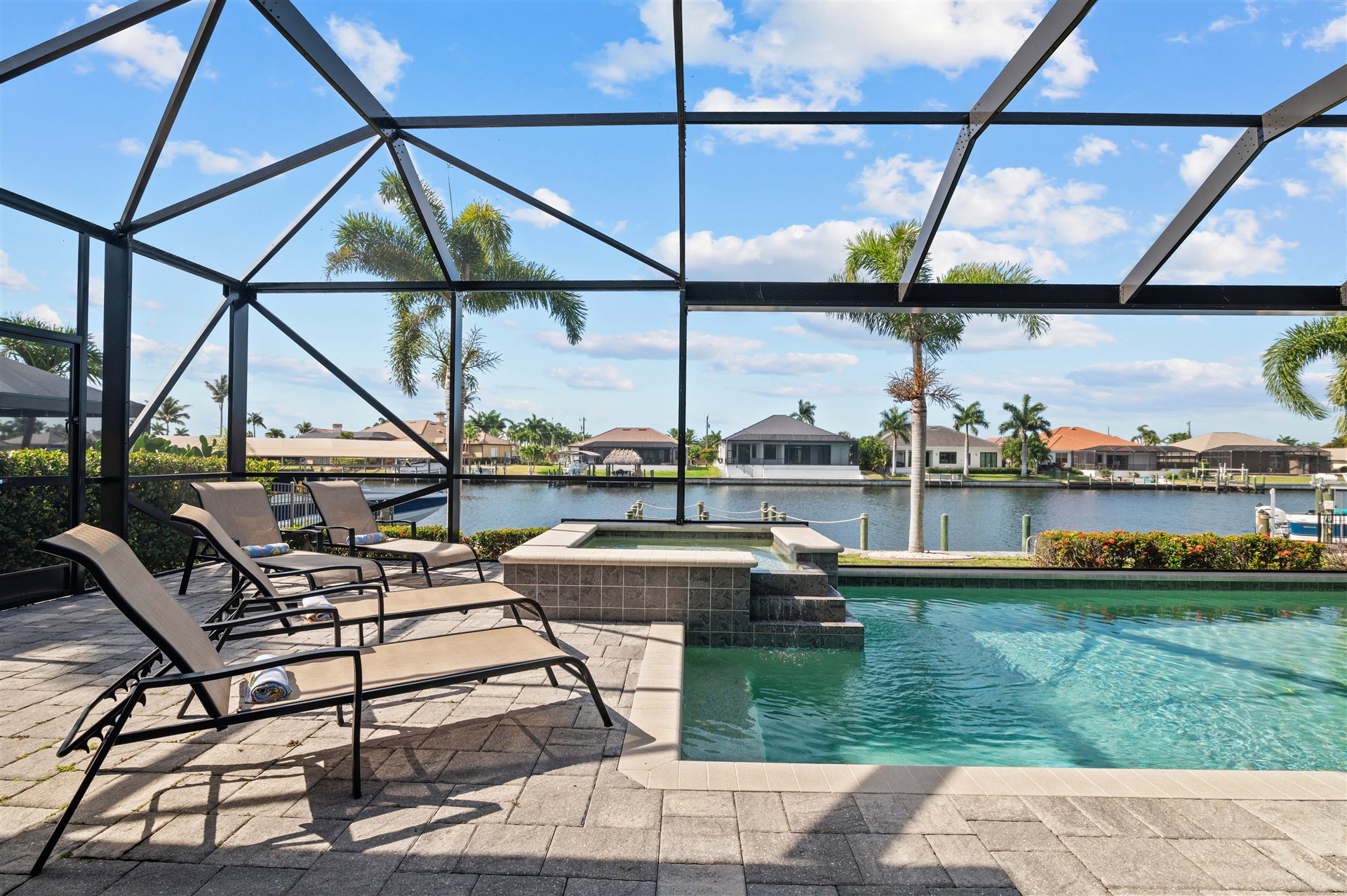 Sonnenliegen am Pool und Whirlpool unter dem Screen-Enclosure