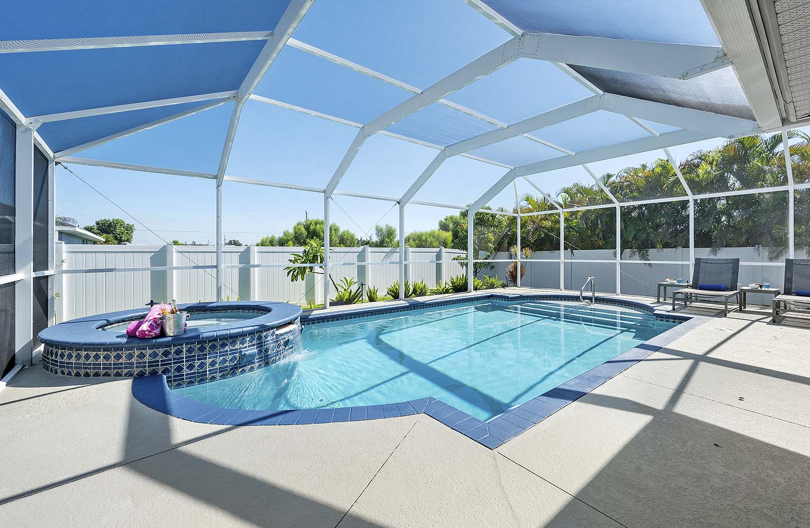 Salzwasser-Pool mit Whirlpool und überdachter Lanai im Garten.