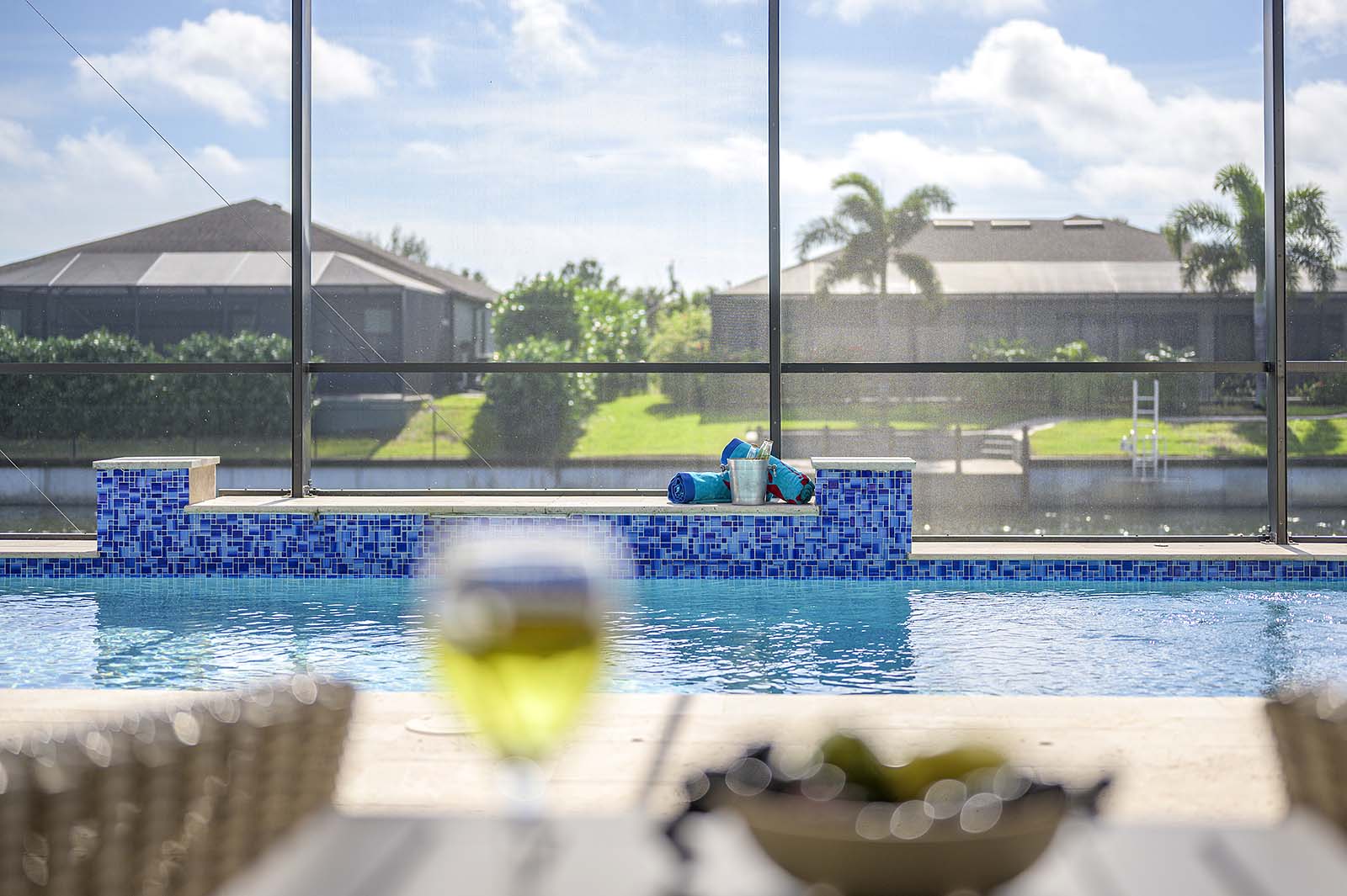Außenansicht des Ferienhauses mit beheiztem Pool und großer Lanai mit Grill.
