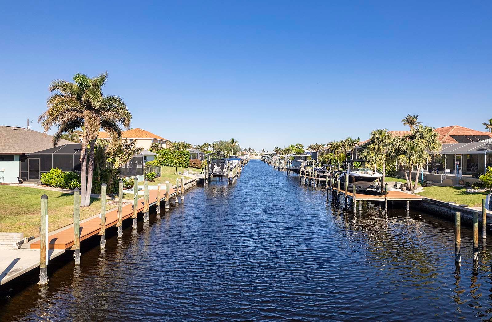 Terrasse am Kanal mit privatem Bootsdock und Blick aufs Wasser.